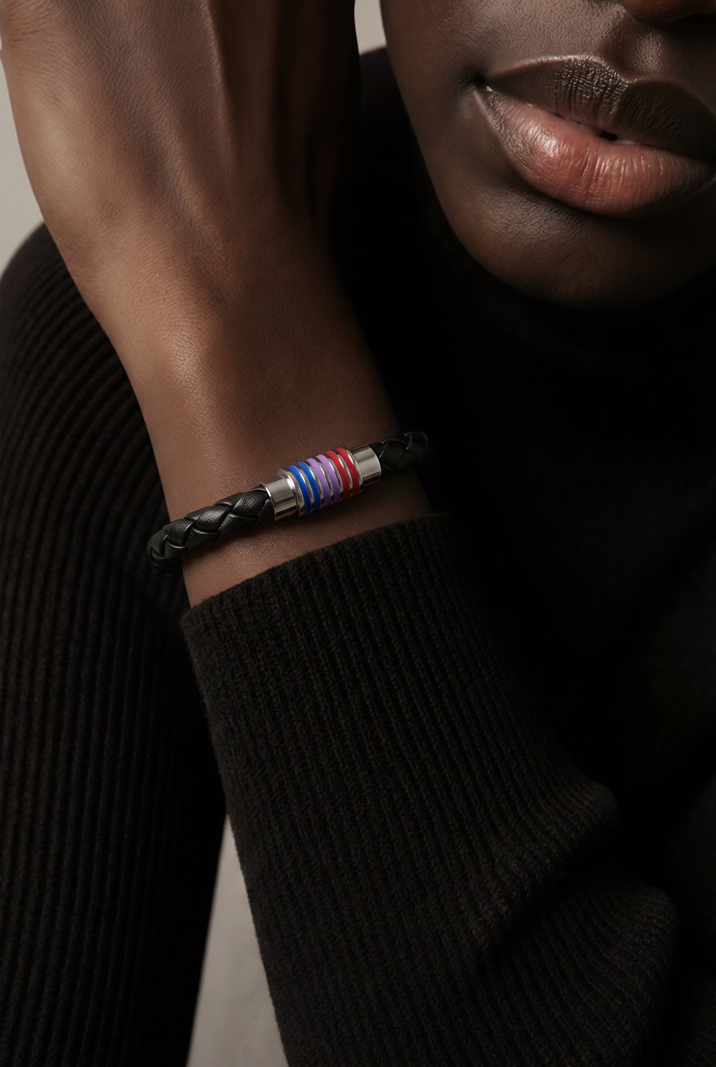 model wearing Black braided Bisexual Pride bracelet with pink purple and blue enamel accents