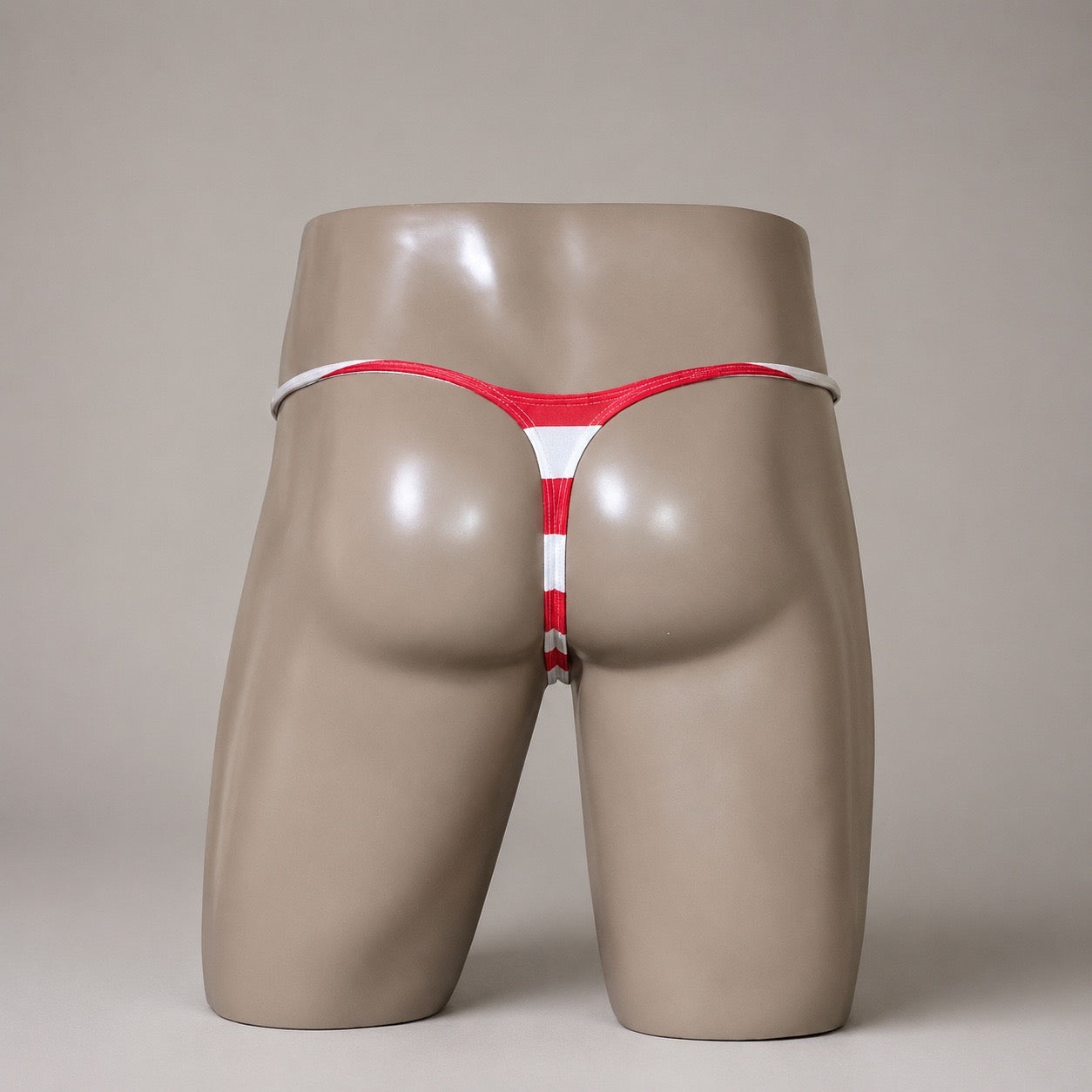 Rear View of Stars & Stripes red and white striped men’s Muscle thong by PapiMalo Gear