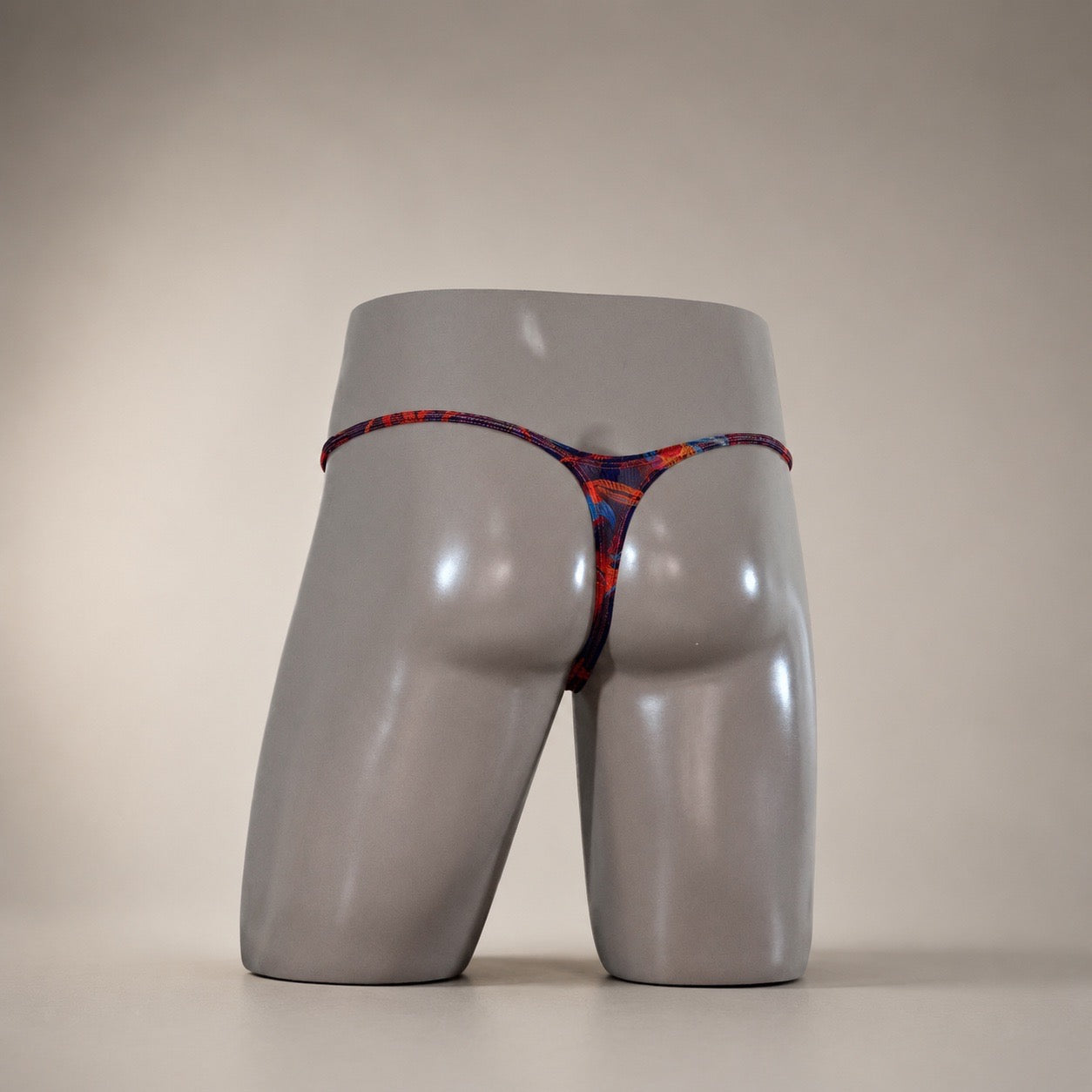 Rear view of Molten Ember dark multicolor abstract men's Muscle thong by PapiMalo Gear