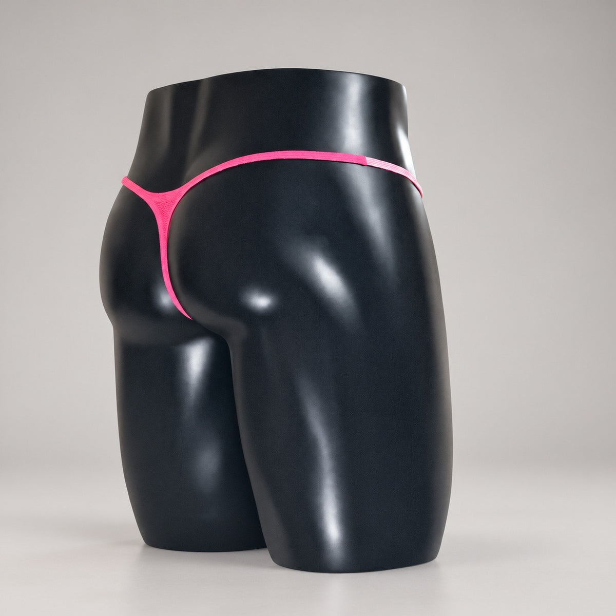 Back angle of Pink Reveal Muscle Thong with vivid hot pink thong back by PapiMalo Gear