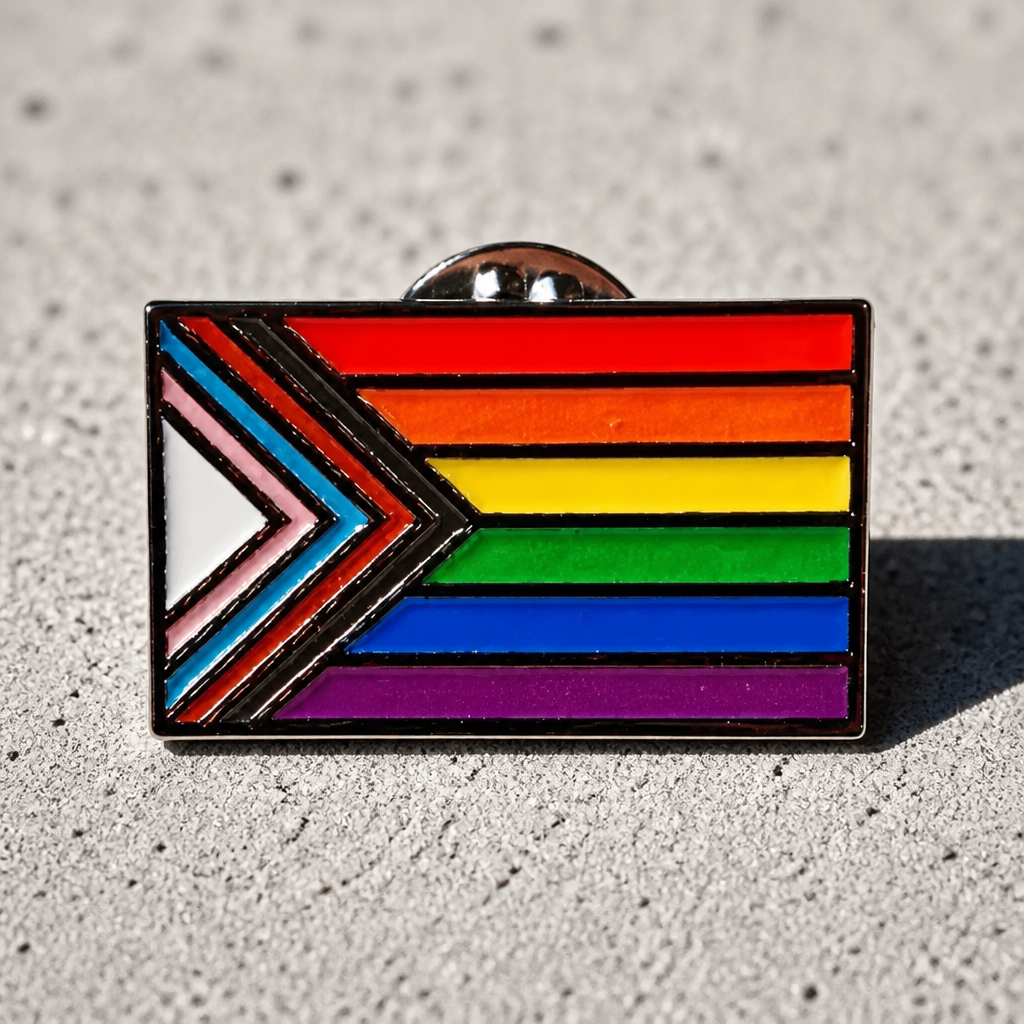 Progress Pride Flag enamel pin with vibrant inclusive LGBTQ+ Pride flag colors on a concrete surface