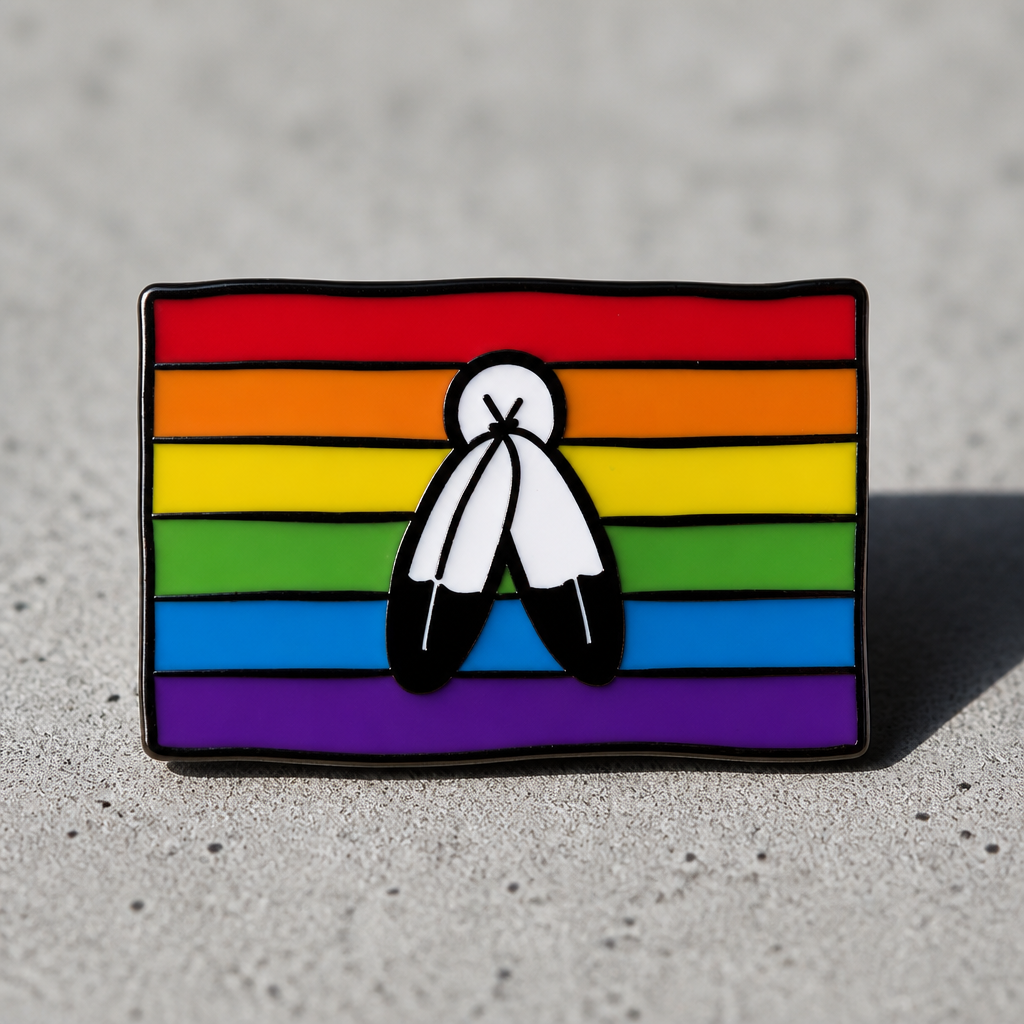 Two-Spirit Pride Flag enamel pin with rainbow stripes and symbolic feather design on a concrete surface