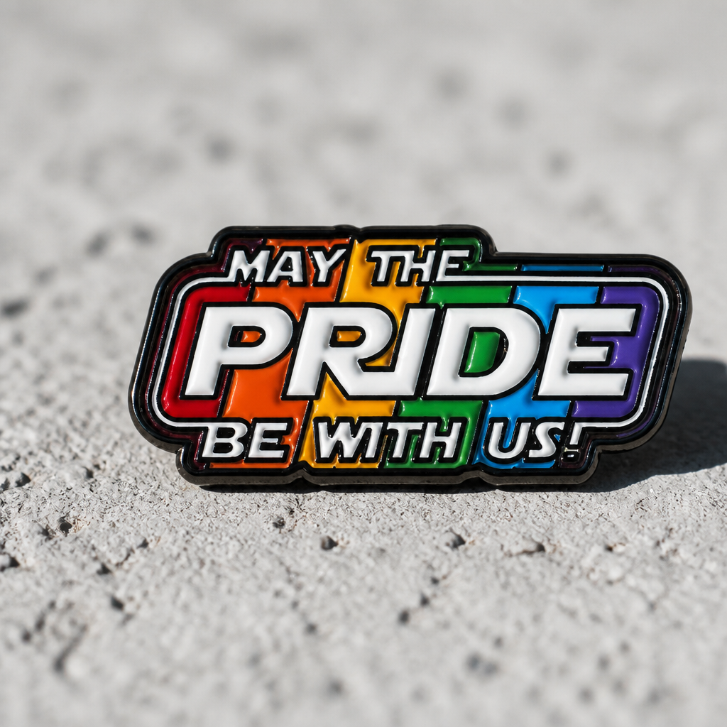 Funny May the Pride Be With Us enamel pin featuring rainbow-inspired sci-fi parody artwork and colorful LGBTQ fandom energy, on a concrete surface