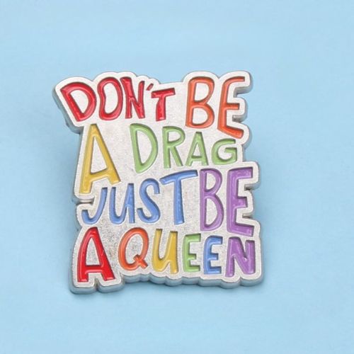 Colorful Don’t Be A Drag Just Be A Queen enamel pin with rainbow lettering