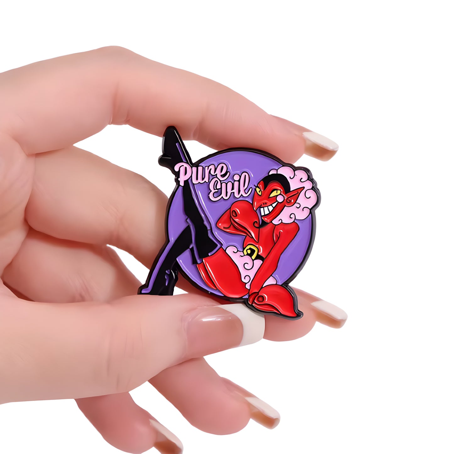 Pure Evil Devil in Drag enamel pin featuring glamorous red devil pin-up artwork held in a hand