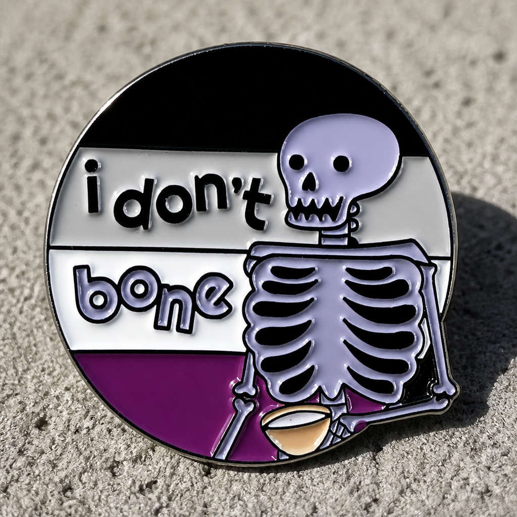 Ace Pride skeleton enamel pin with “I Don’t Bone” text on a concrete surface
