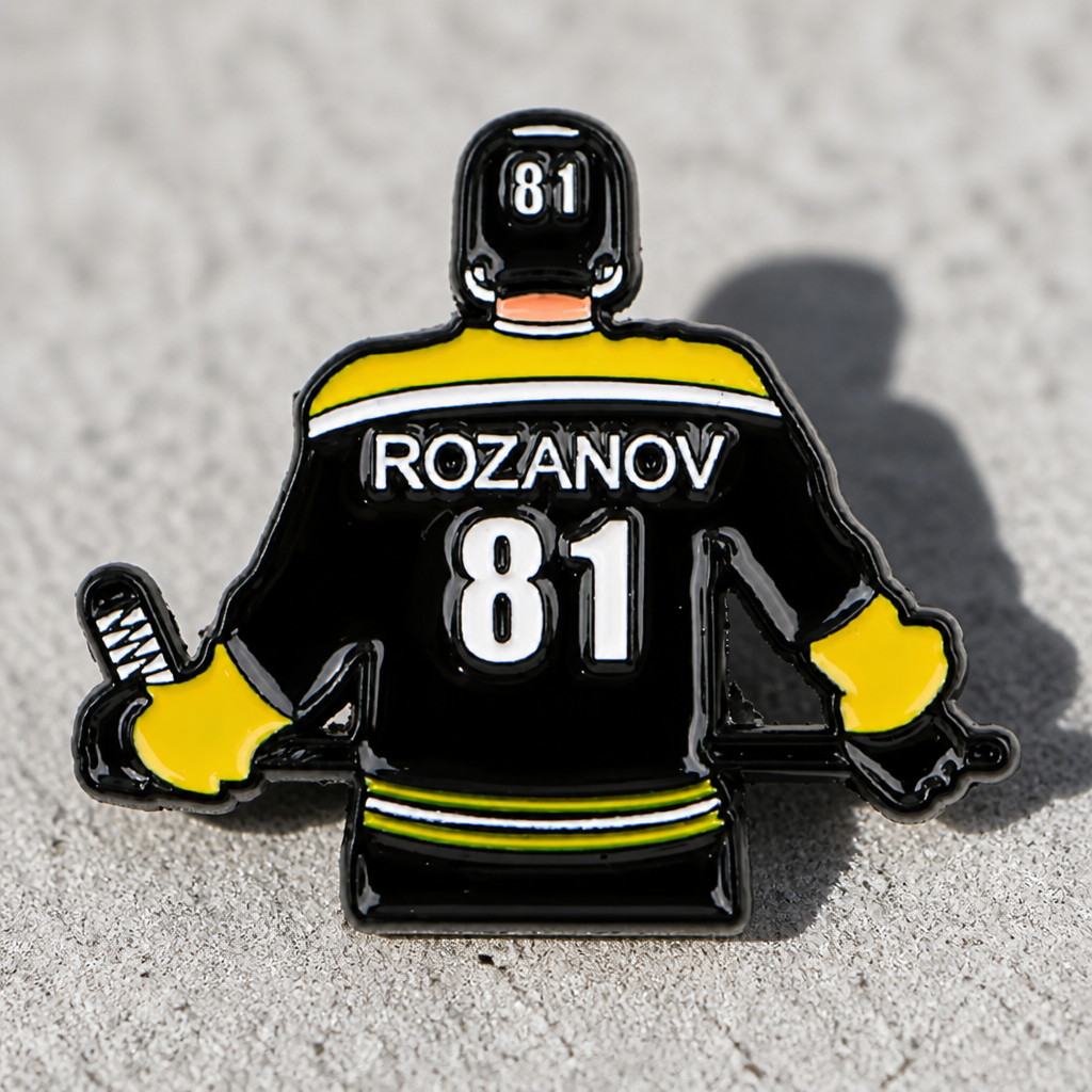 Heated Rivalry Rozanov away jersey enamel pin with hockey uniform design and number 81 on a concrete surface