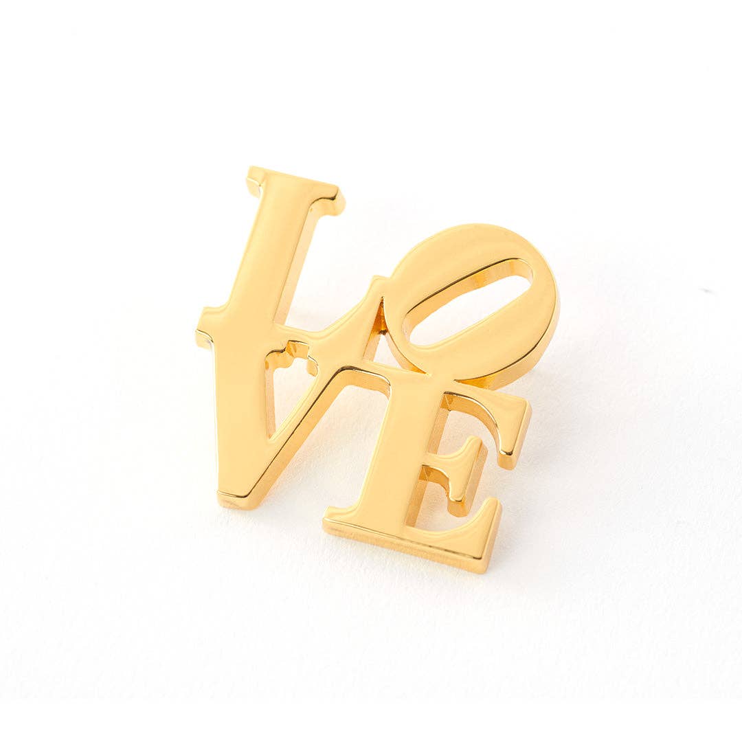 Gold plated LOVE pin inspired by the iconic Robert Indiana artwork featuring the tilted O design