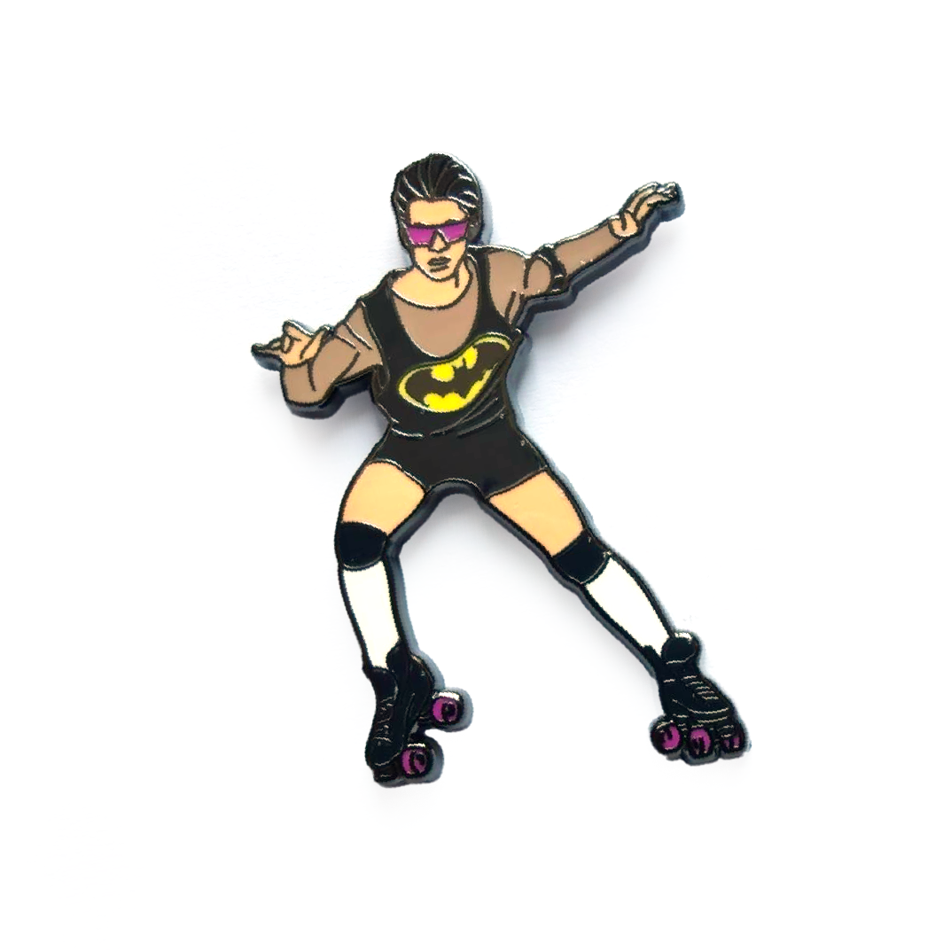 Hard enamel pin featuring a retro roller skater wearing sunglasses and a black outfit with roller skates in a playful disco-inspired design