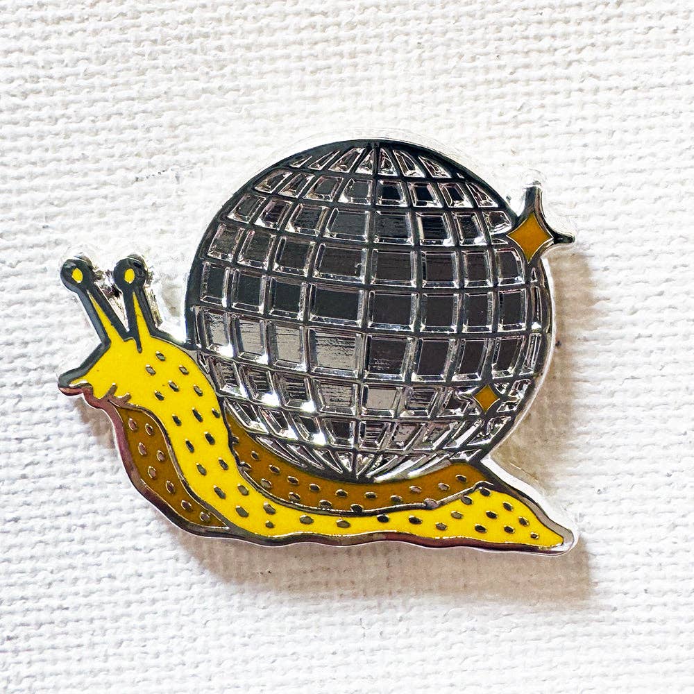 Disco Snail enamel pin featuring a yellow snail carrying a mirrored disco ball shell