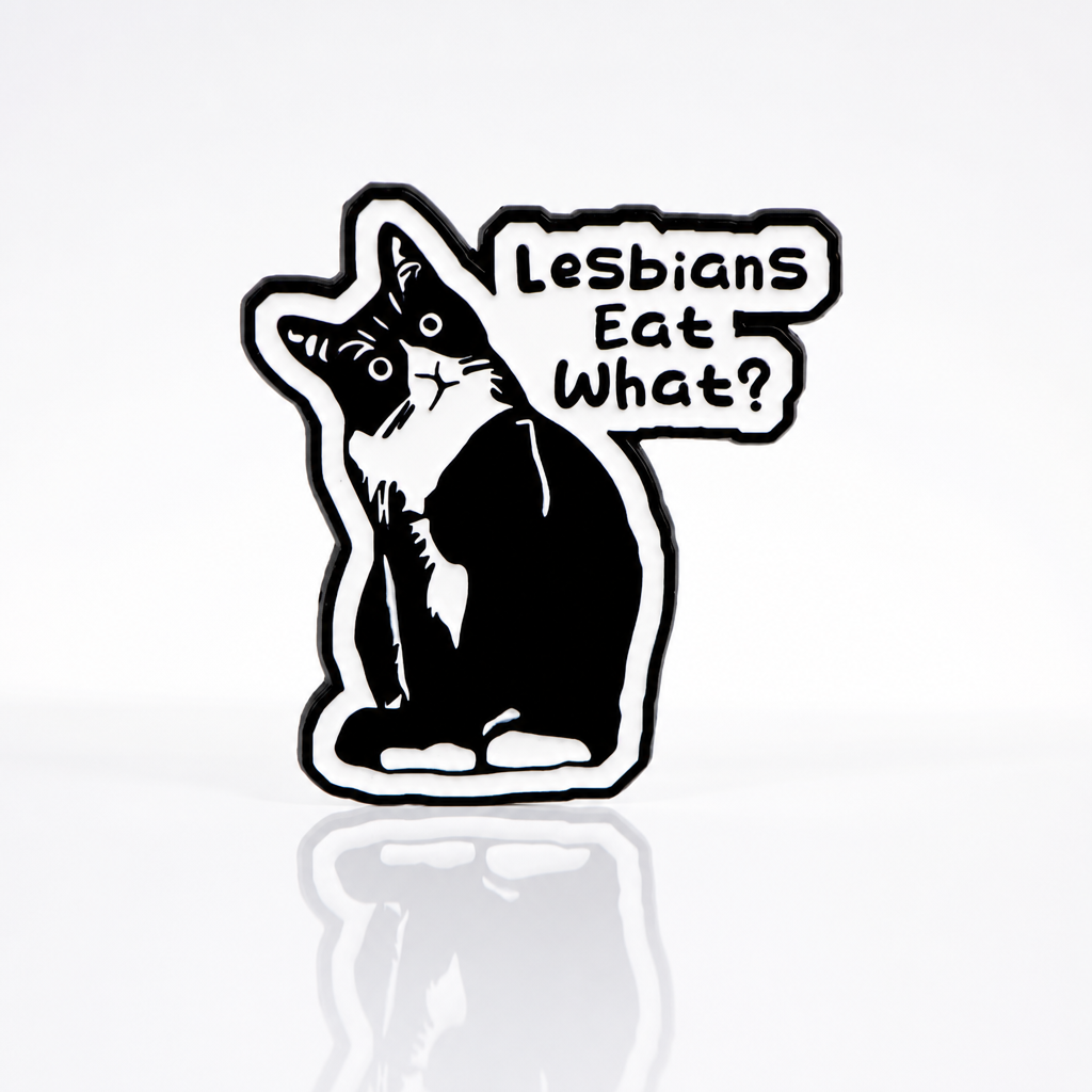 Funny tuxedo cat enamel pin with the phrase “Lesbians Eat What?”