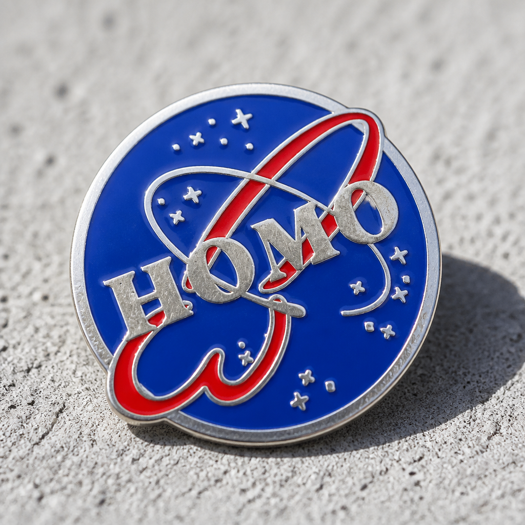 HOMO Space Program enamel pin featuring a retro space-agency-inspired logo design in blue and red on a concrete surface