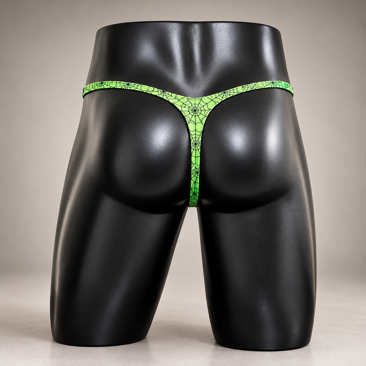 Back view of Web of Desire Classic Thong featuring neon green fabric with black spiderweb print, men's Classic thong by PapiMalo Gear.