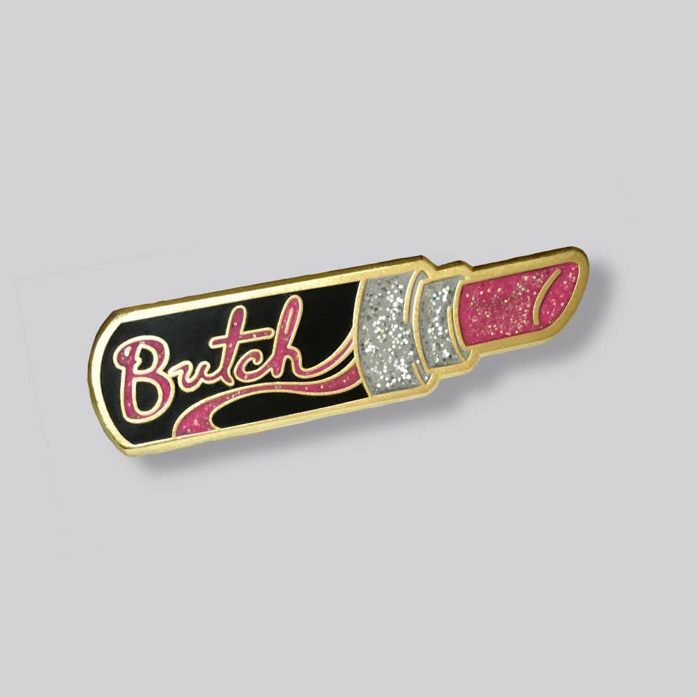 Butch Lipstick enamel pin featuring glitter pink lipstick artwork with gold-tone details
