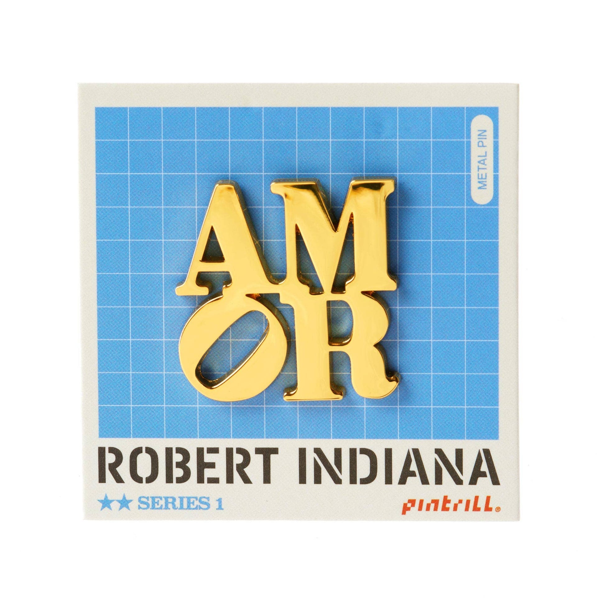 Officially licensed Robert Indiana AMOR enamel pin featuring the iconic stacked lettering in a polished gold finish, on a blue grid backing card