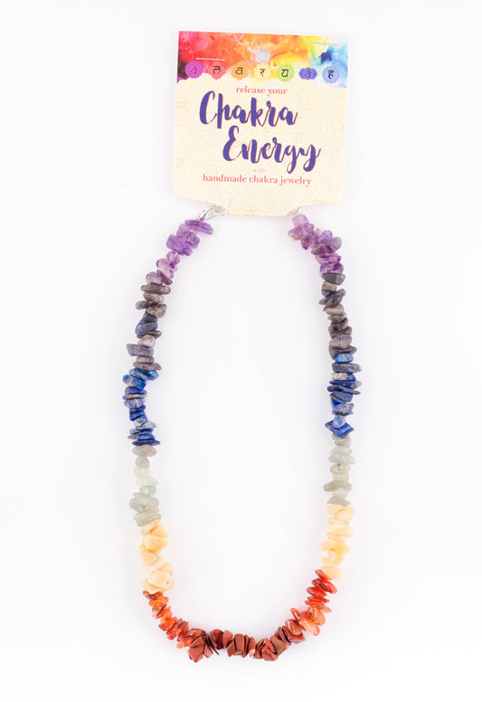 Artisan chakra gemstone necklace made with colorful natural stone chips arranged in traditional chakra colors.