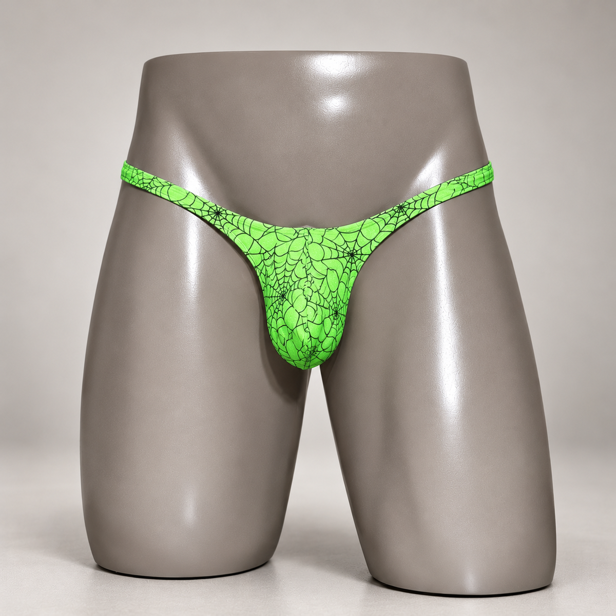 Front view of Web of Desire Classic Thong featuring electric green and black spiderweb pattern, men's Classic thong by PapiMalo Gear.