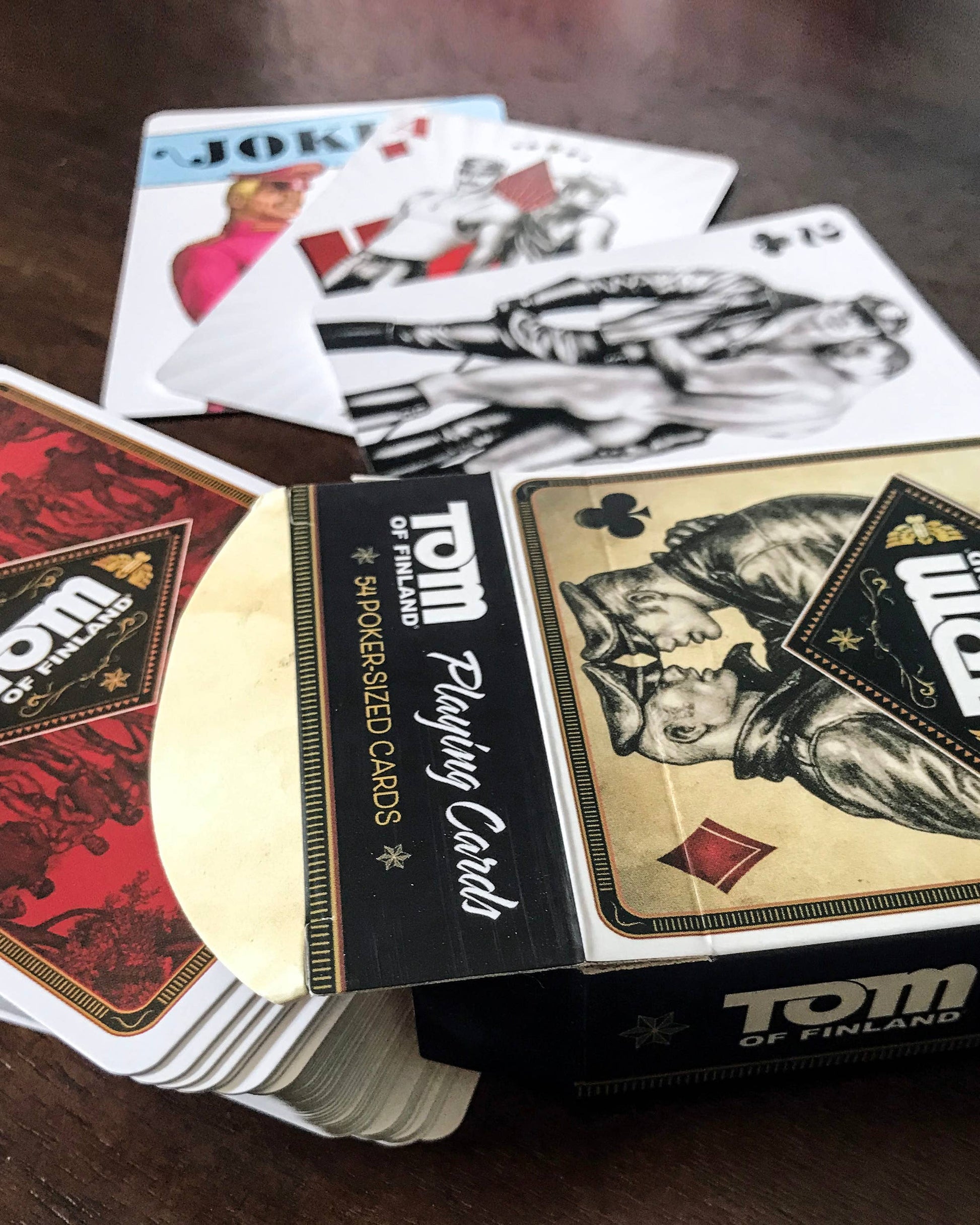 Official Tom of Finland collectible playing card deck featuring 54 illustrated poker cards with iconic LGBTQ+ artwork.