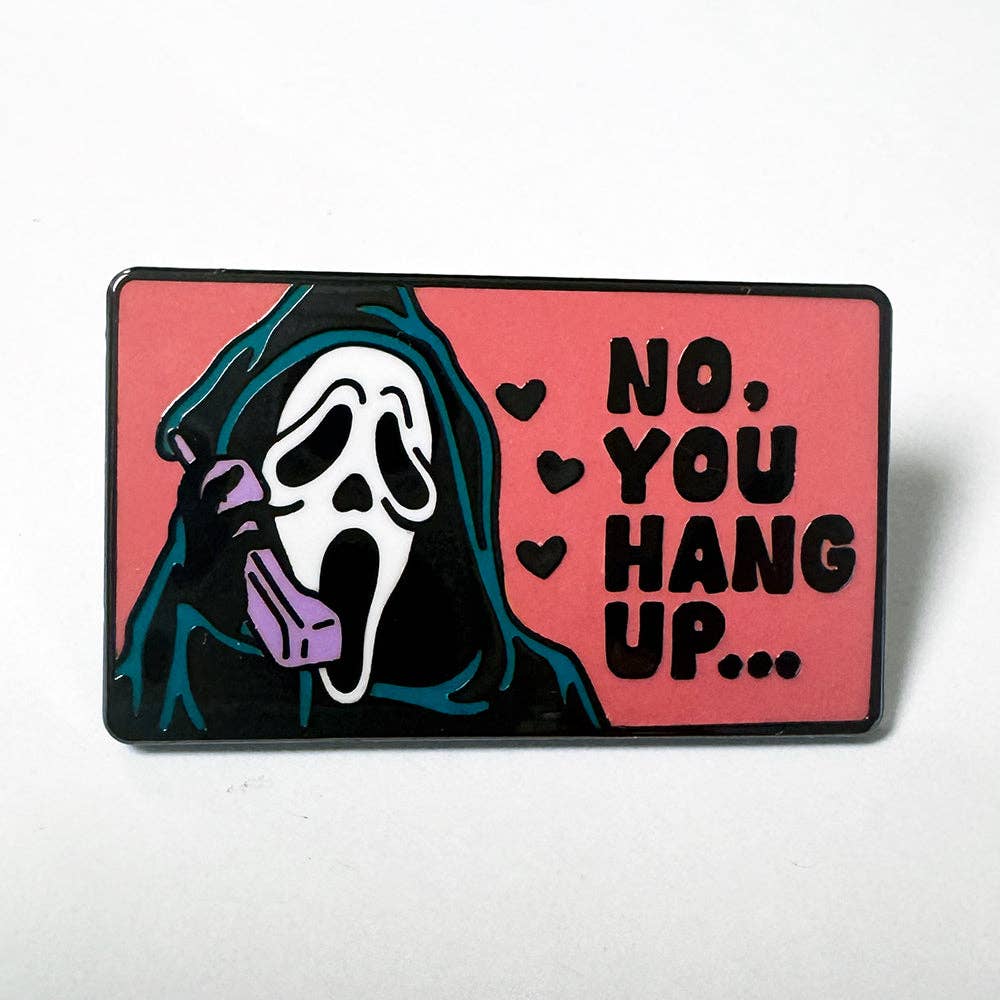 Hard enamel pin featuring a masked horror movie caller holding a pink telephone with the phrase No You Hang Up