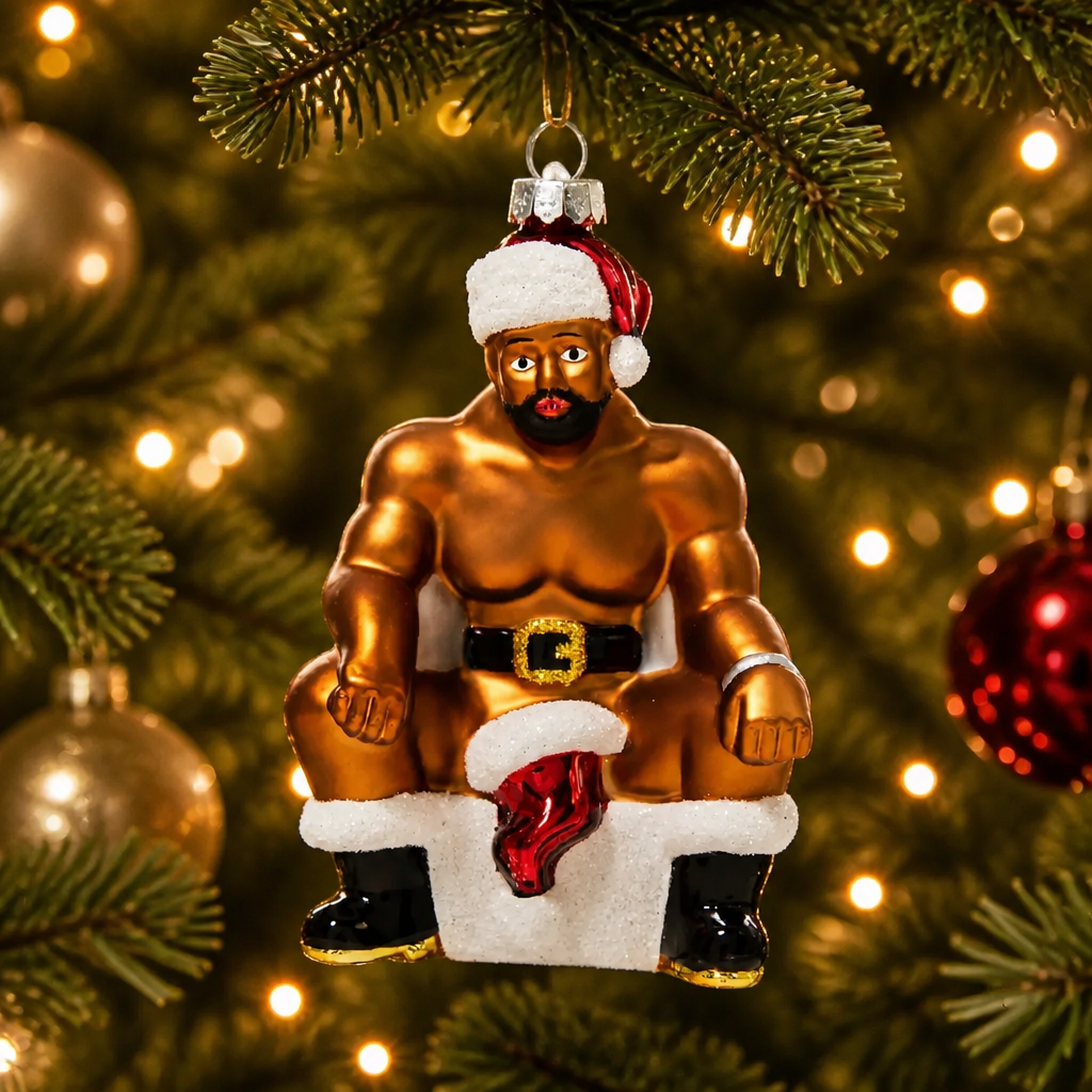 Hand-painted glass Christmas ornament featuring a muscular bearded Santa sitting on the naughty stool wearing a Santa hat and boots.