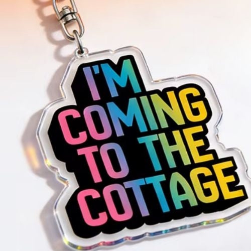 Heated Rivalry acrylic keychain with “I’m Coming To The Cottage” rainbow quote design