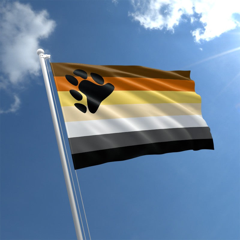 Bear Brotherhood Pride outdoor flag with paw print and multicolor bear stripes against a blue sky