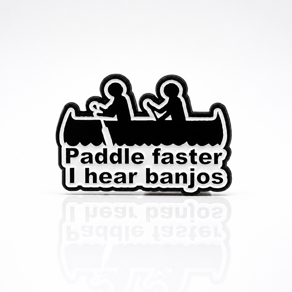 Funny enamel pin featuring two people in a canoe with Paddle Faster I Hear Banjos text