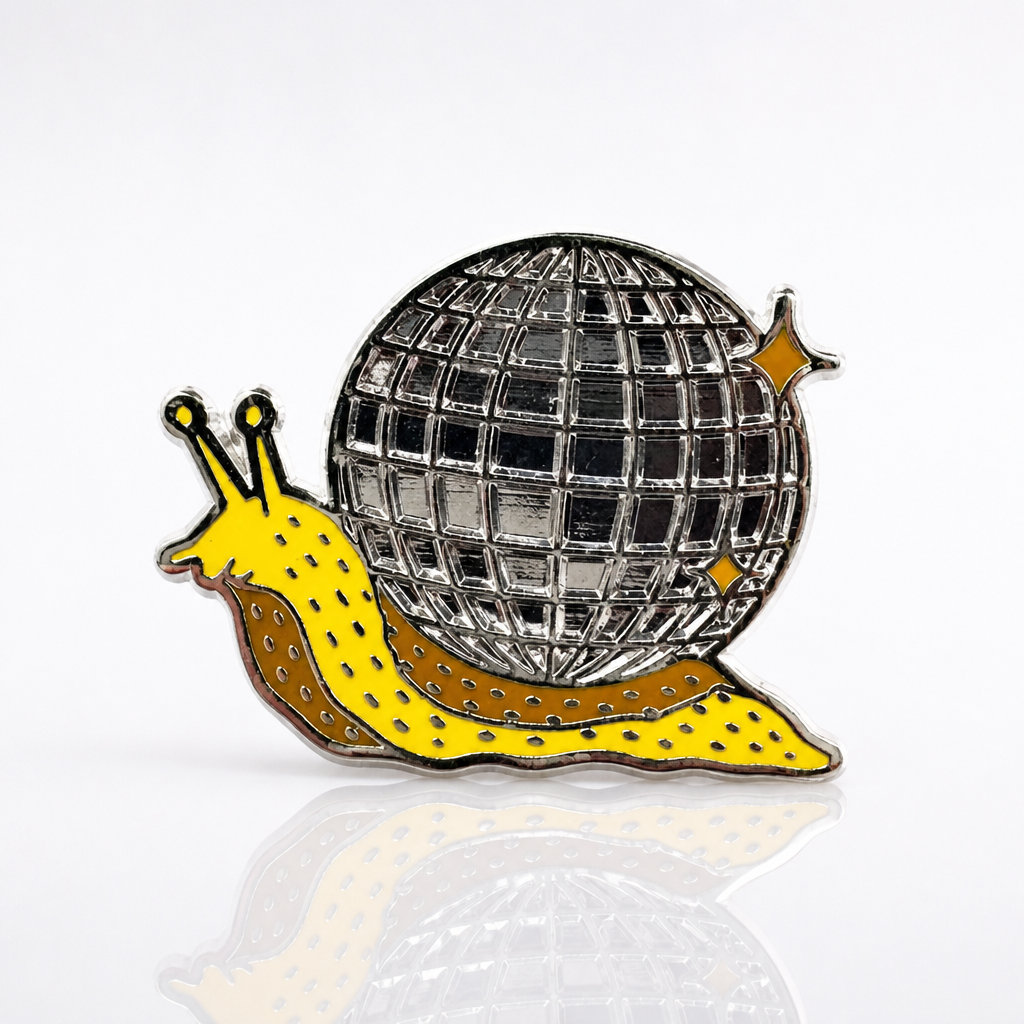 Disco Snail enamel pin featuring a yellow snail carrying a mirrored disco ball shell