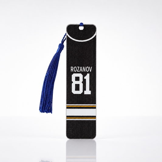 Double-sided Heated Rivalry steel bookmark featuring Hollander #24 on one side and Rozanov #81 on the reverse with blue tassel.