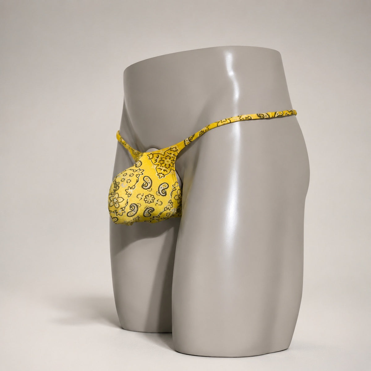 Angled view of PapiMalo Golden Bandit yellow paisley Muscle thong