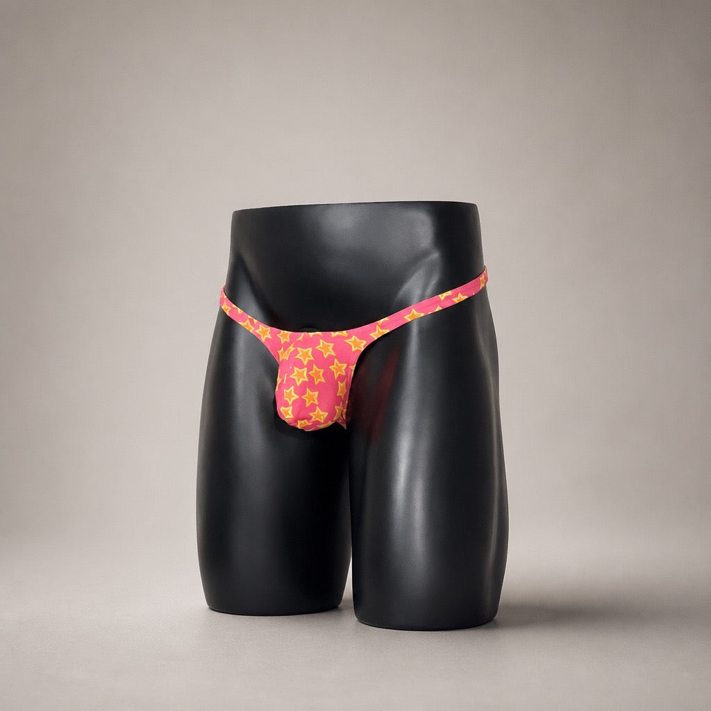 Front View of Star Power hot pink and yellow star-print men’s Muscle thong by PapiMalo Gear