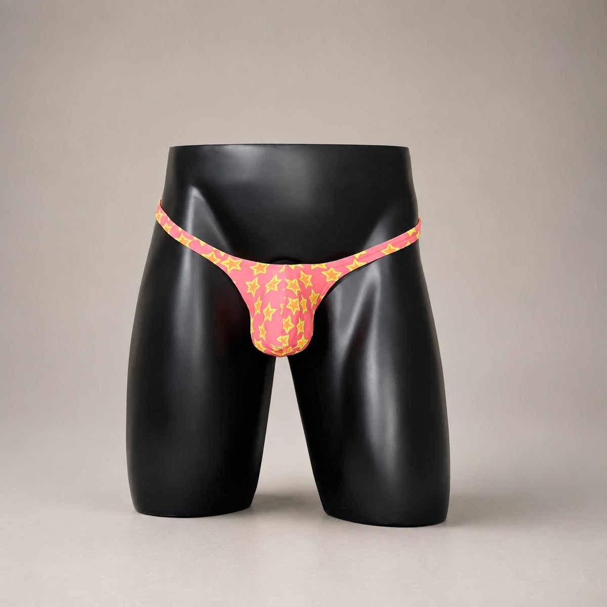 Front View of Star Power hot pink and yellow star-print men’s Muscle thong by PapiMalo Gear