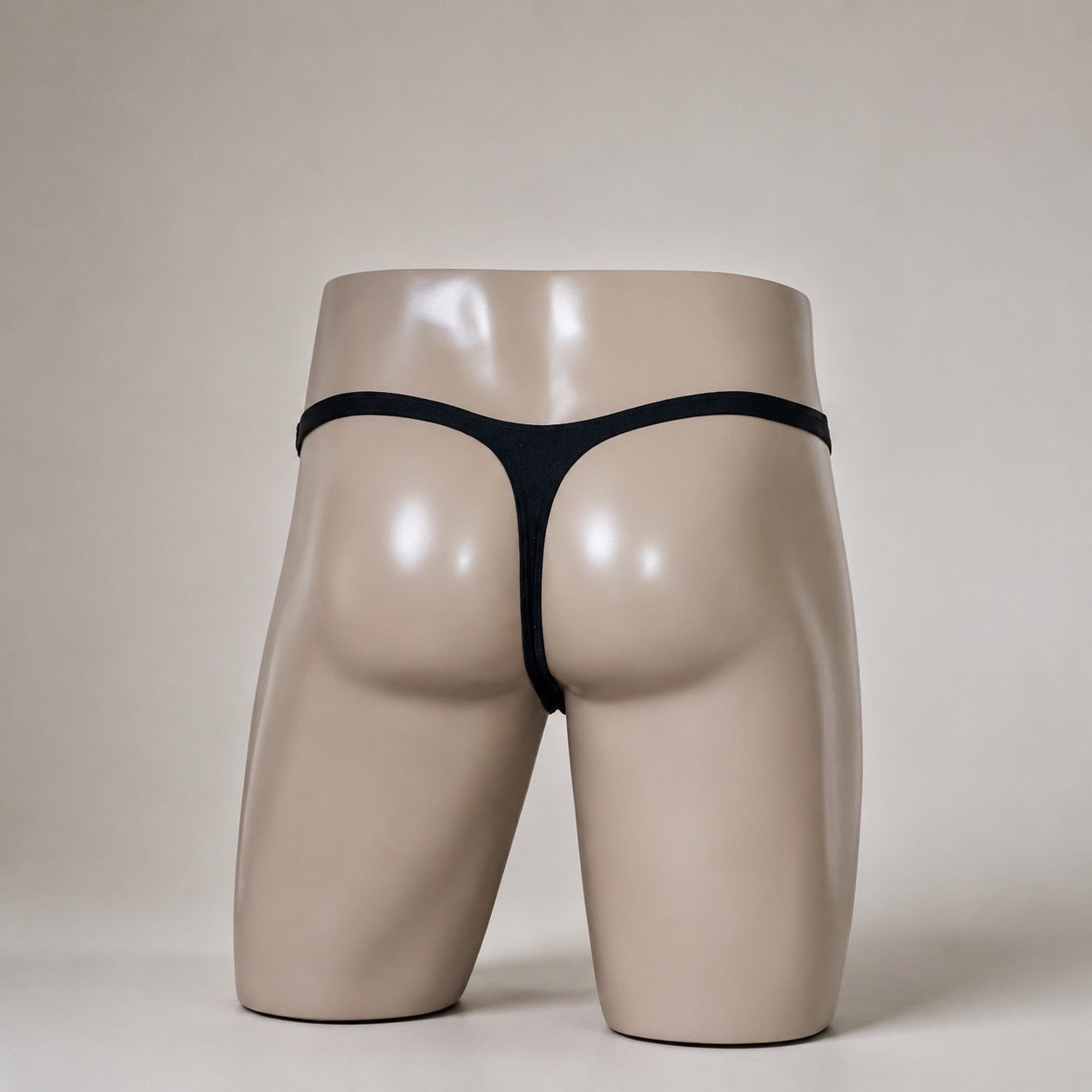 Rear View of Aqua Voltage men’s Muscle thong with solid black thong back by PapiMalo Gear