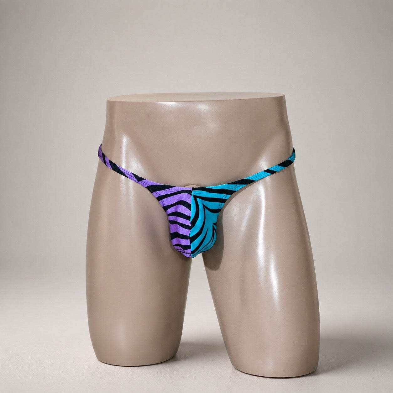 Front View of Aqua Voltage turquoise, purple and black men’s Muscle thong by PapiMalo Gear