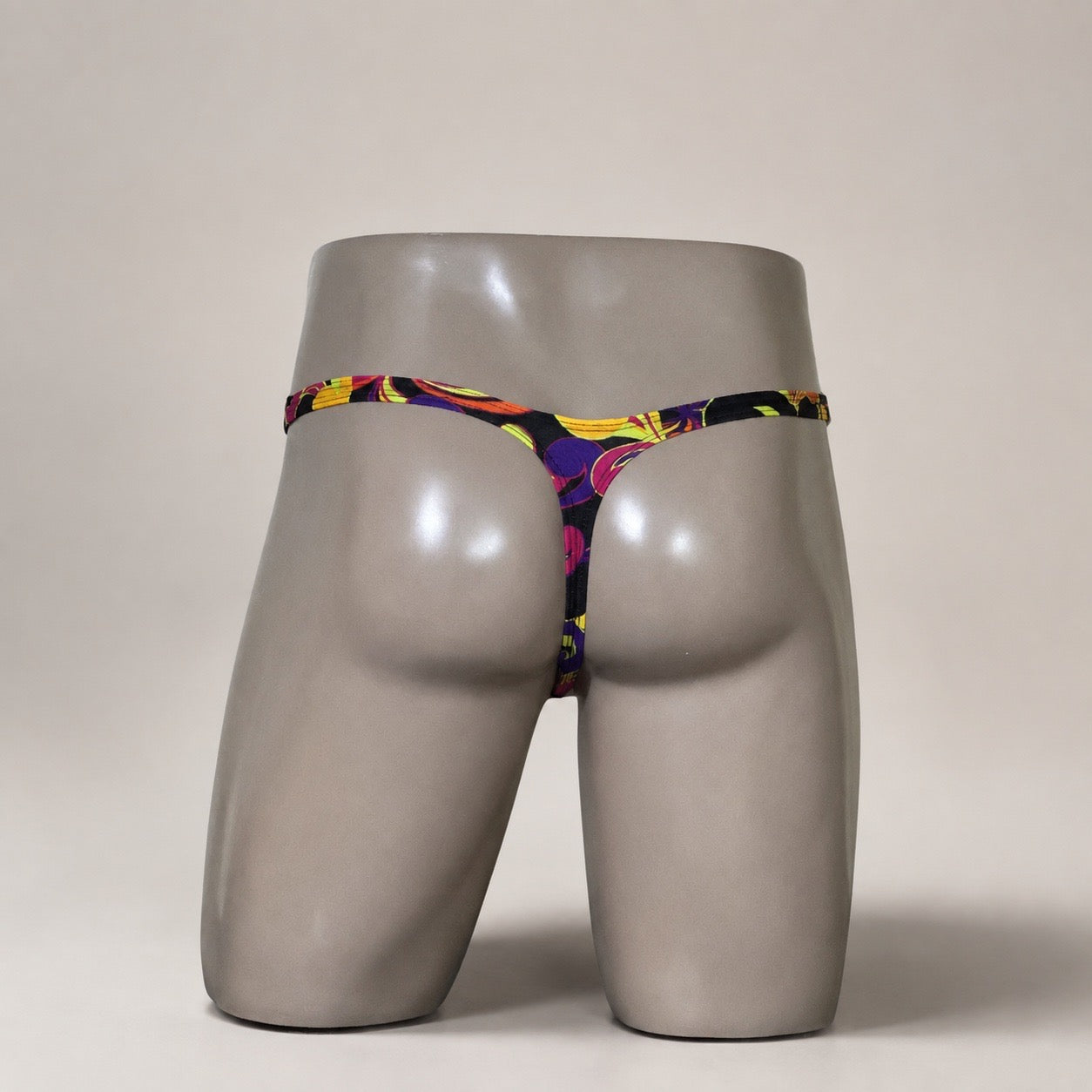 Back View of Disco Inferno Classic Thong black multicolor men’s thong by PapiMalo Gear