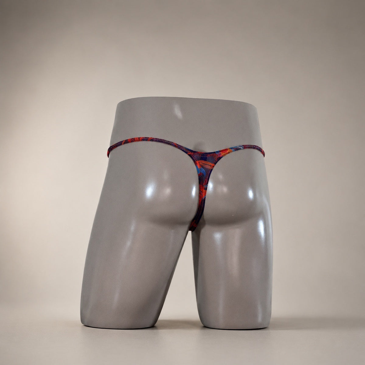 Rear view of Molten Ember dark multicolor abstract men's Muscle thong by PapiMalo Gear