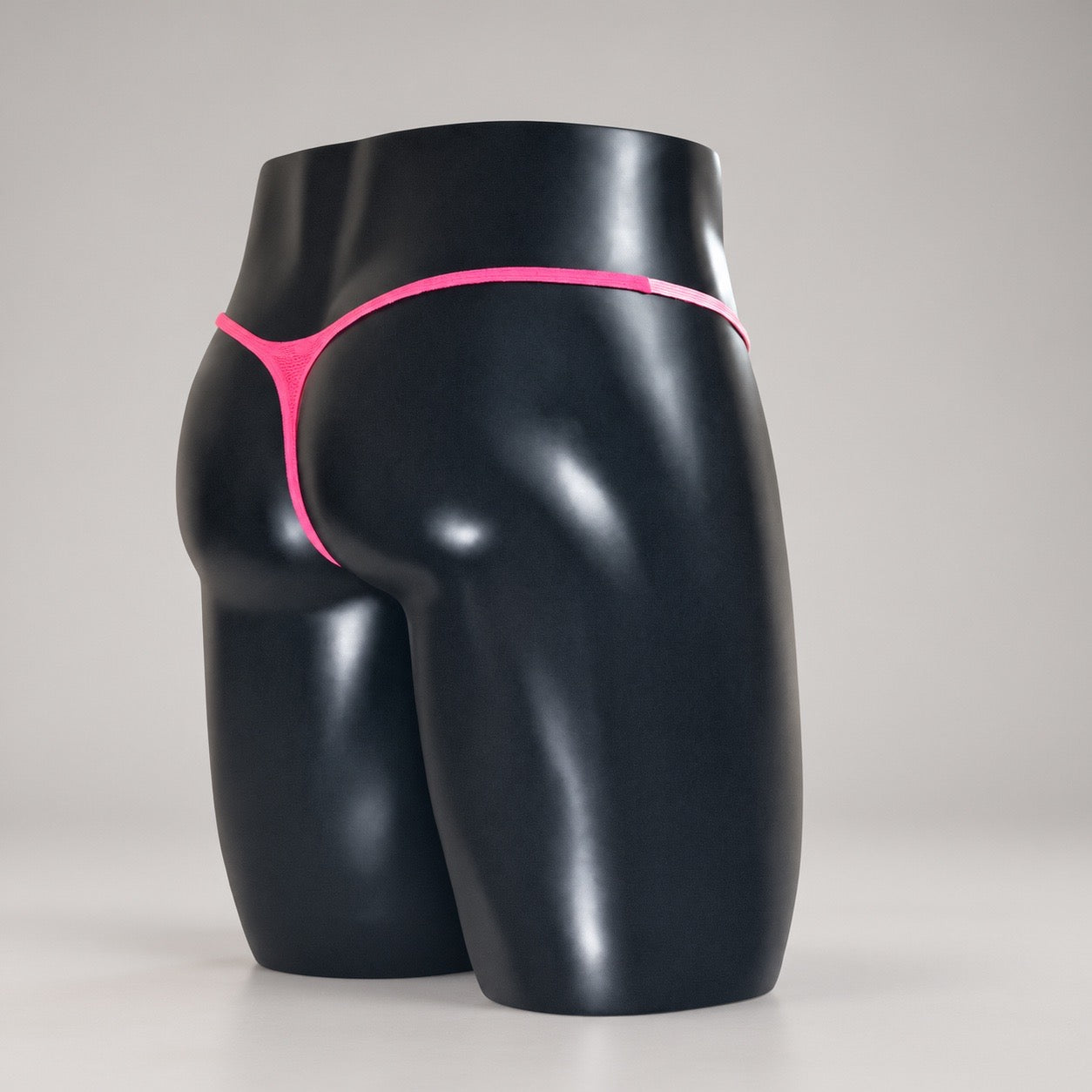 Back angle of Pink Reveal Muscle Thong with vivid hot pink thong back by PapiMalo Gear