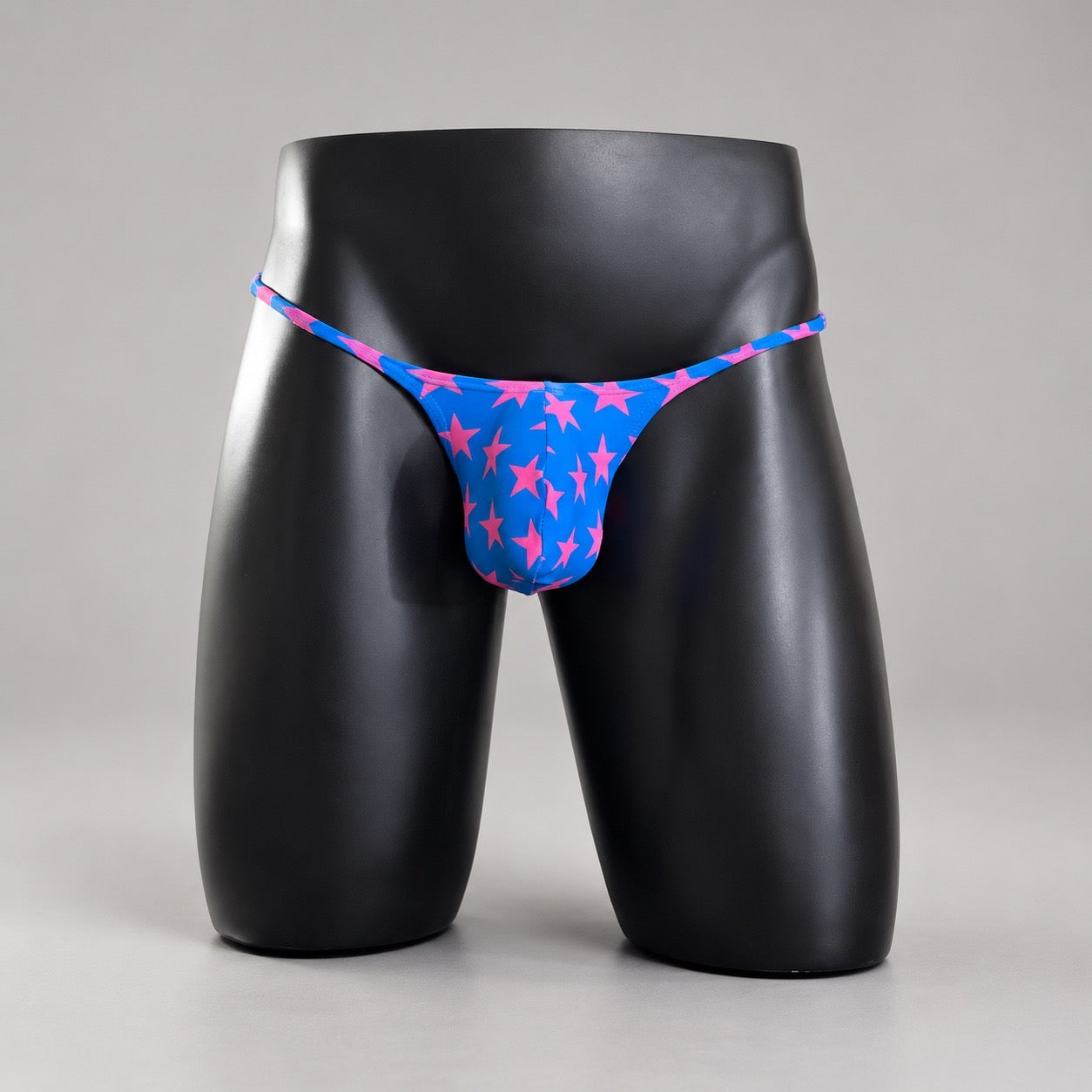 Front View of Starstruck Muscle Thong with hot pink stars on brilliant blue by PapiMalo Gear