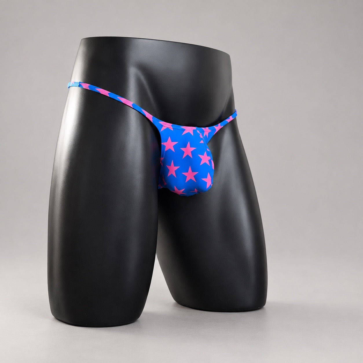 Front Side View of Starstruck Muscle Thong blue and hot pink star-print men’s thong by PapiMalo Gear