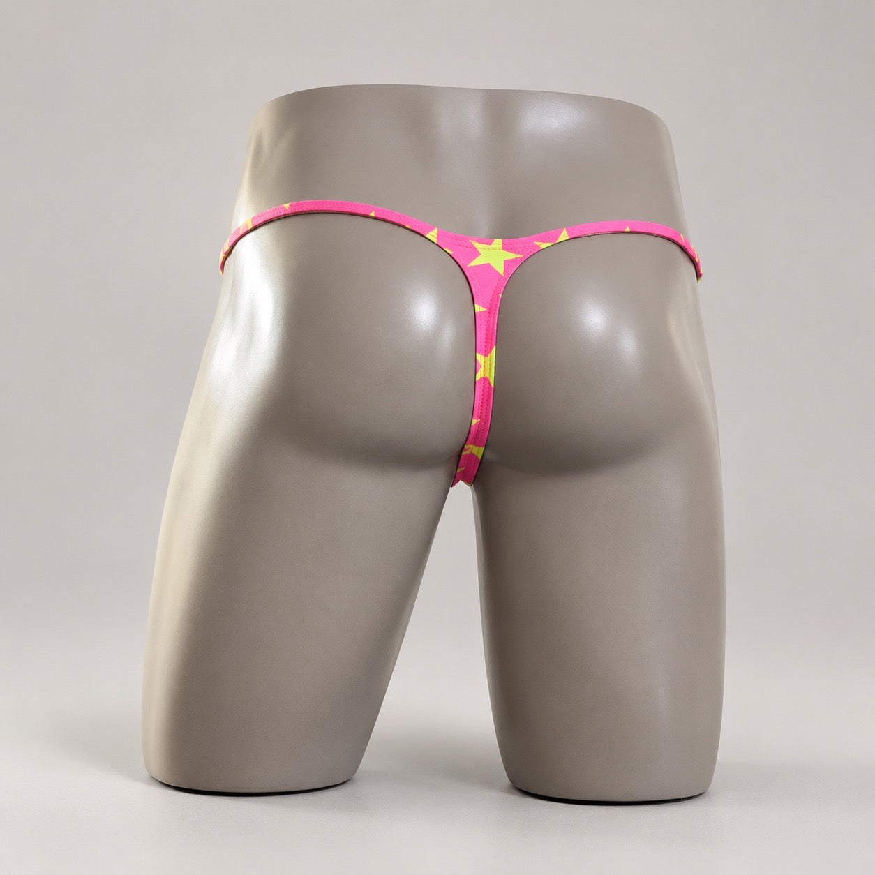 Back View of Popstar Muscle Thong with yellow-green stars and narrow thong back by PapiMalo Gear