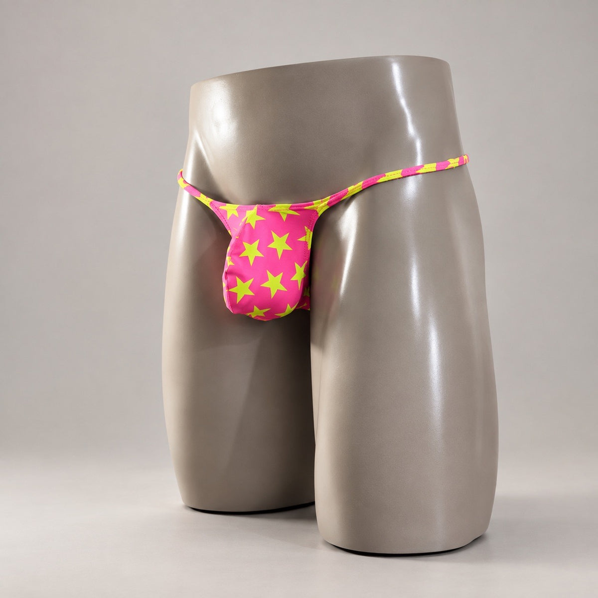 Front Side View of Popstar Muscle Thong with hot pink and yellow-green star print by PapiMalo Gear