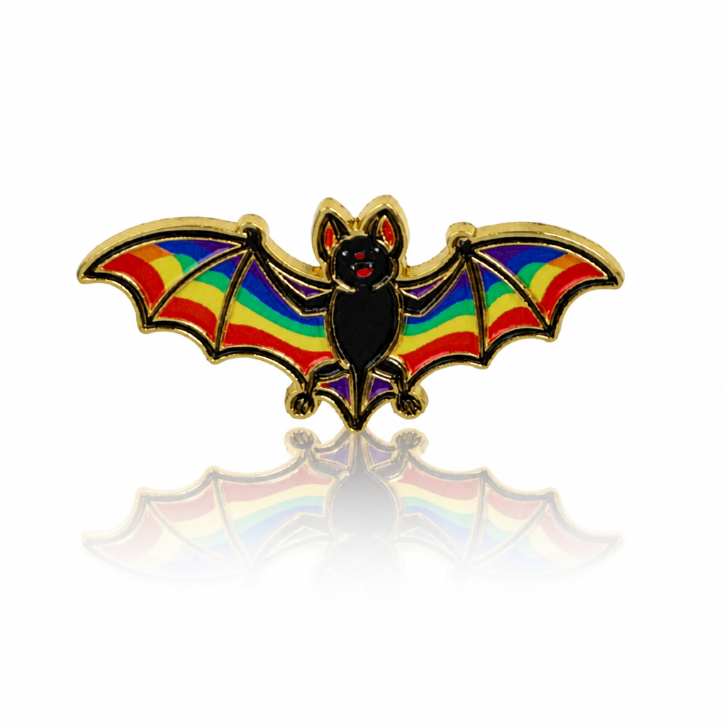 Rainbow Pride bat enamel pin with black body, rainbow-striped wings, and gold-tone details