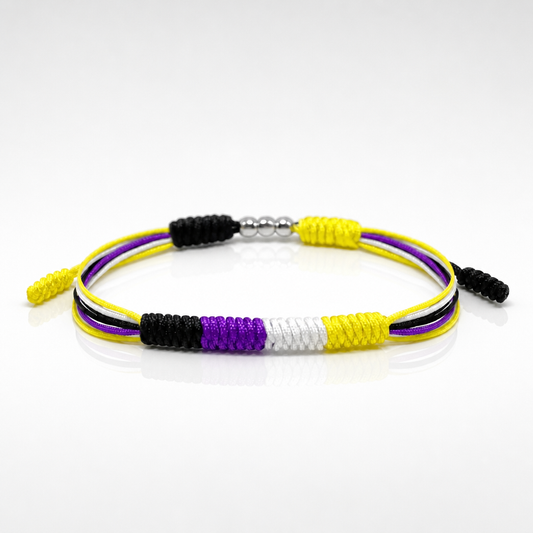 Nonbinary Pride braided cord bracelet with adjustable closure in yellow white purple and black pride colors on a white background