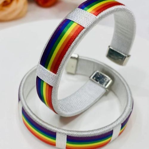 White satin rainbow pride cuff bracelet with colorful woven stripe design