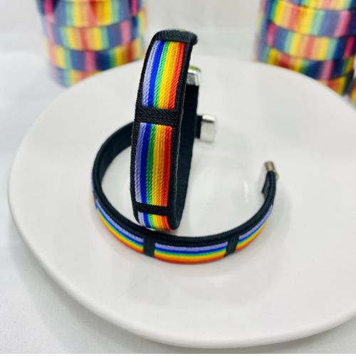 Rainbow pride woven cuff bracelet with colorful striped fabric design