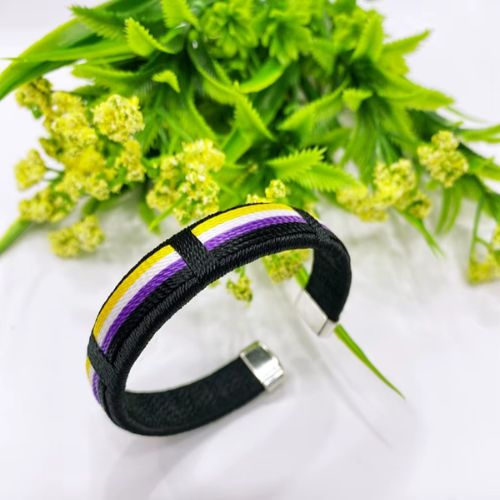 Nonbinary pride woven cuff bracelet with yellow white purple and black stripe design