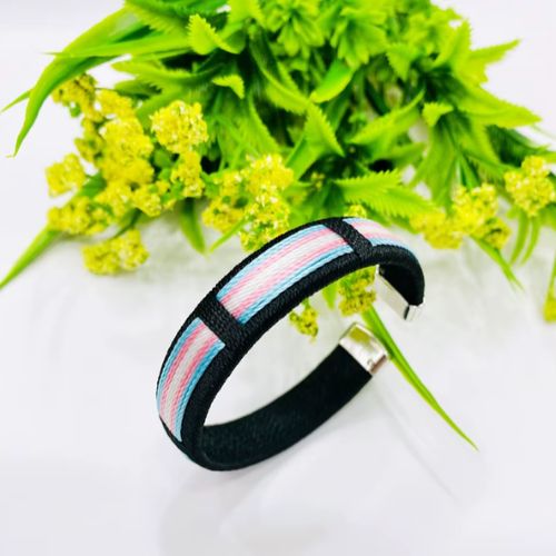 Trans pride woven cuff bracelet with pastel blue pink and white stripe design