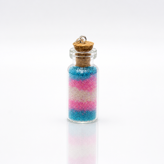 Trans pride bottle necklace with layered pink blue and white micro-beads inside tiny glass vial pendant