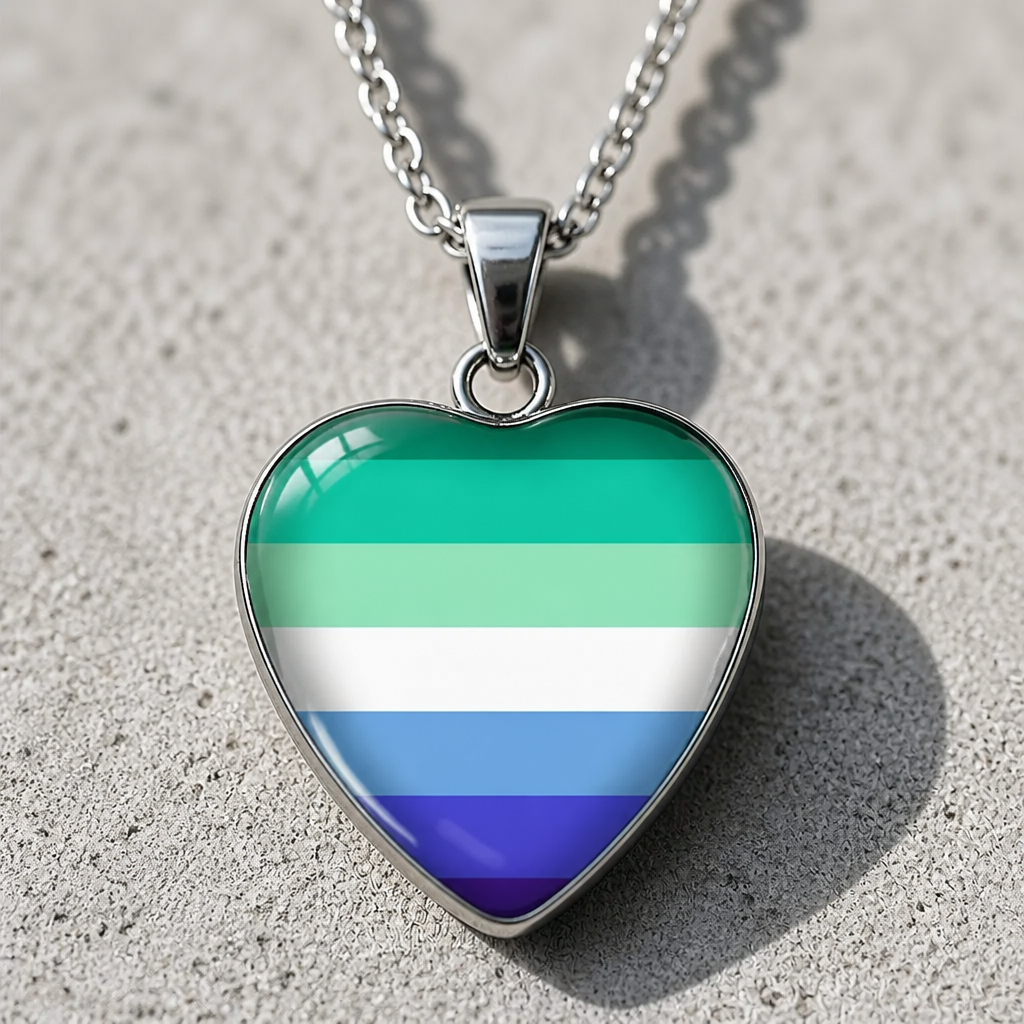 Men Loving Men Pride Heart Pendant Necklace with glossy heart pendant featuring the MLM pride flag on a silver-tone chain on a cement surface