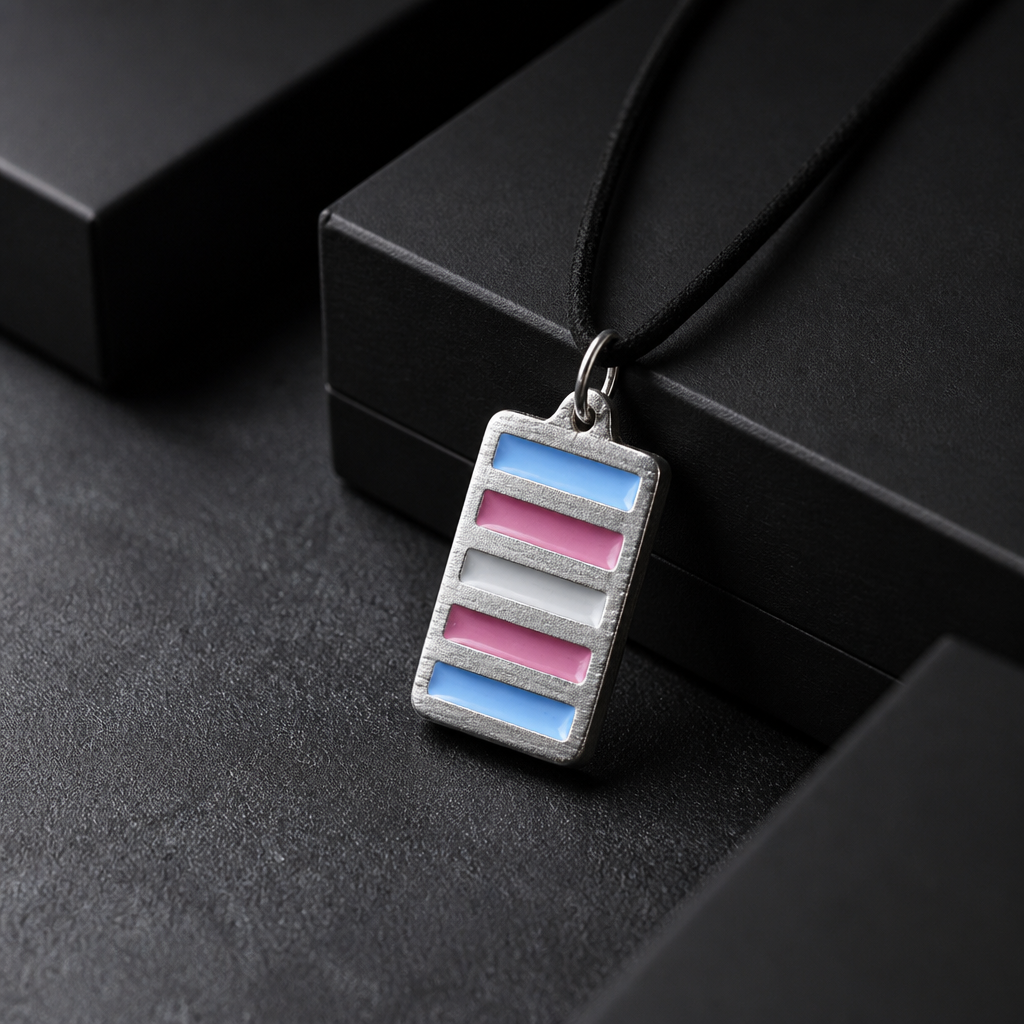 Handcrafted pewter pendant featuring the Transgender Pride flag in a contemporary geometric design on an adjustable black waxed cord on a black jewelry box
